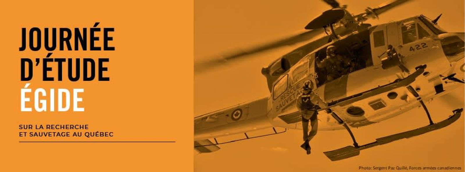 Journée d’étude ÉGIDE sur la recherche et sauvetage au Québec — un sauveteur est hélitreuillé sous un hélicoptère des Forces armées canadiennes.